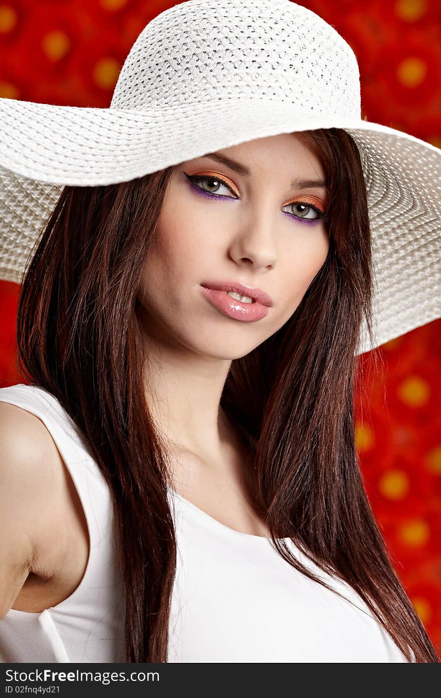 Summer woman over red flowers wall