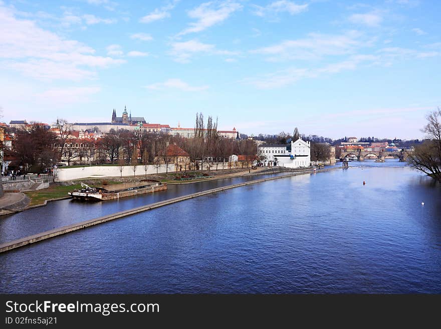 The panoramic View on spring Prague above River Vltava with gothic Castle