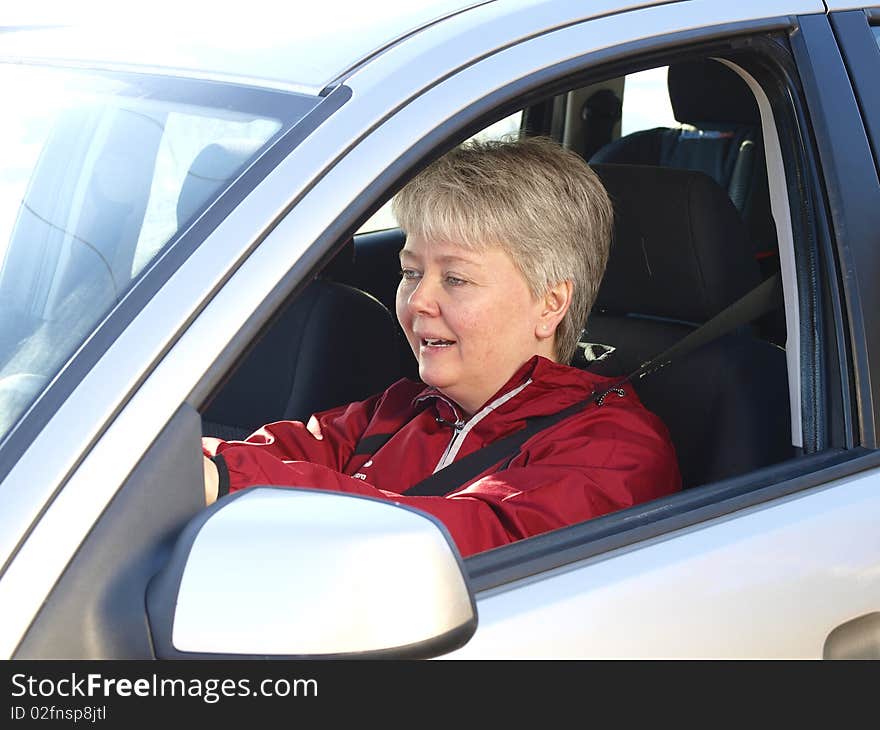 Middelage woman drivng in her car. Middelage woman drivng in her car