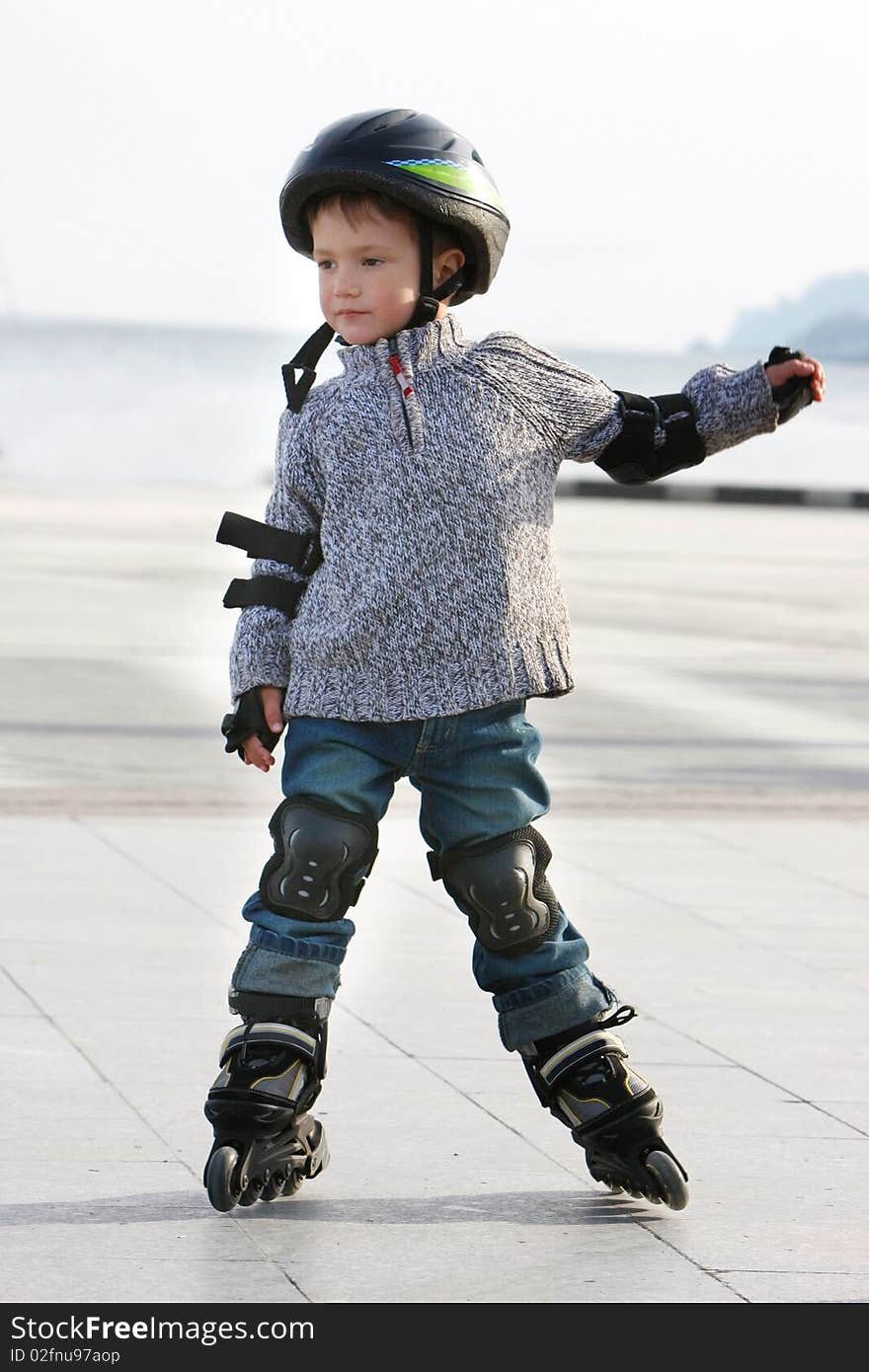 Outdoor portrait of young boy in roller blades