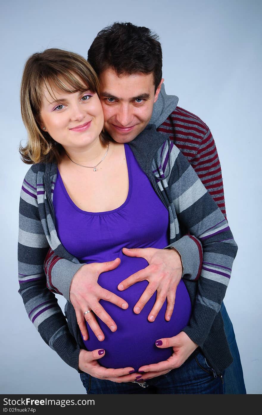 Happy young couple in anticipation of the twins in studio. Happy young couple in anticipation of the twins in studio