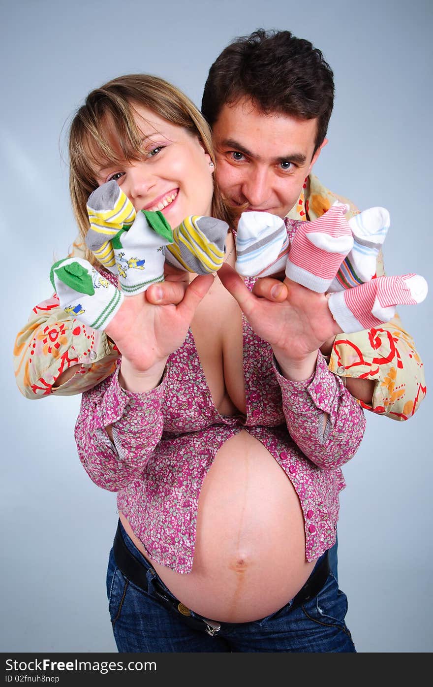 Happy young couple in anticipation of the twins in studio. Happy young couple in anticipation of the twins in studio