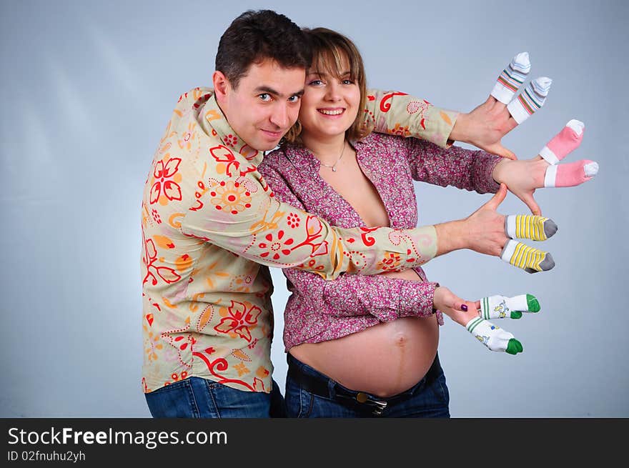 Happy young couple in anticipation of the twins in studio. Happy young couple in anticipation of the twins in studio