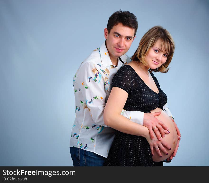 Happy young couple in anticipation of the twins in studio. Happy young couple in anticipation of the twins in studio