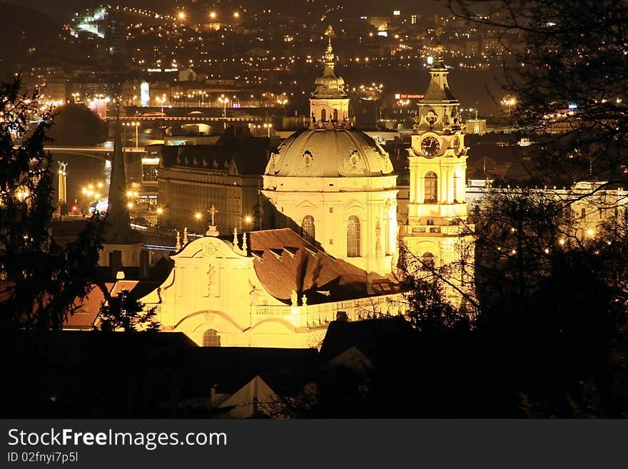 The night View to bright Prague with St. Nicholas' Cathedral. The night View to bright Prague with St. Nicholas' Cathedral