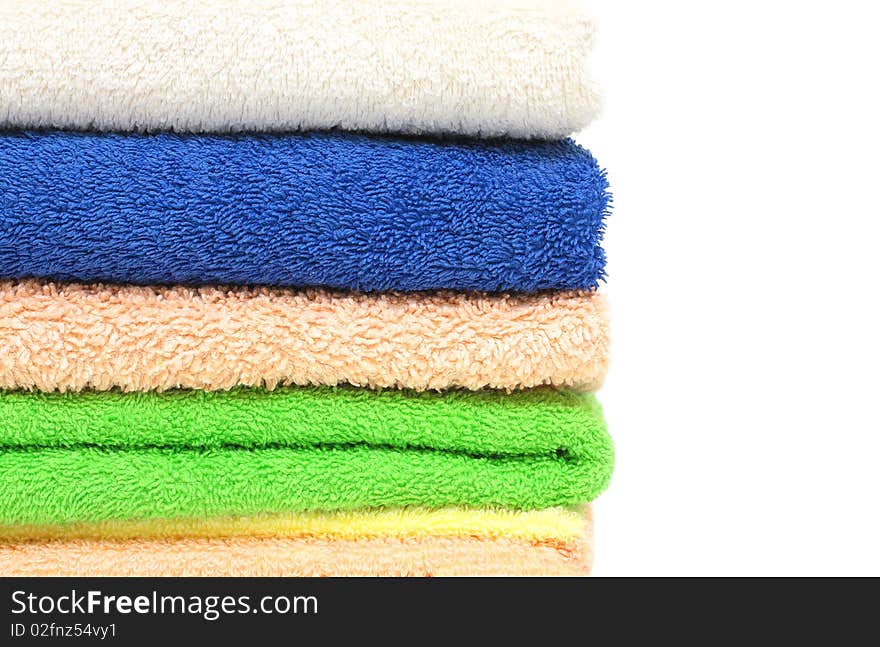 Multicolour towels stacked, isolated on white background