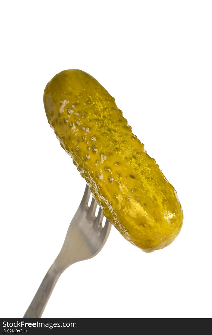 Pickled cucumber on a fork isolated on white