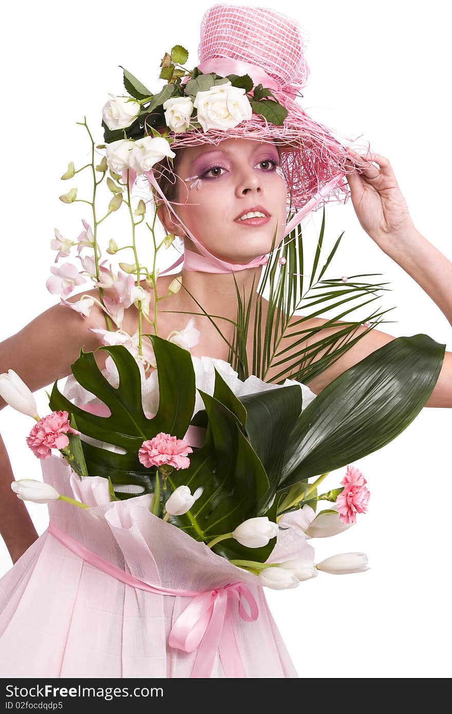 Fashion woman is bouquet of flowers. Elegant model with roses in her hat and and with tulips, carnation, orchids in her dress from wrapping. Fashion woman is bouquet of flowers. Elegant model with roses in her hat and and with tulips, carnation, orchids in her dress from wrapping.