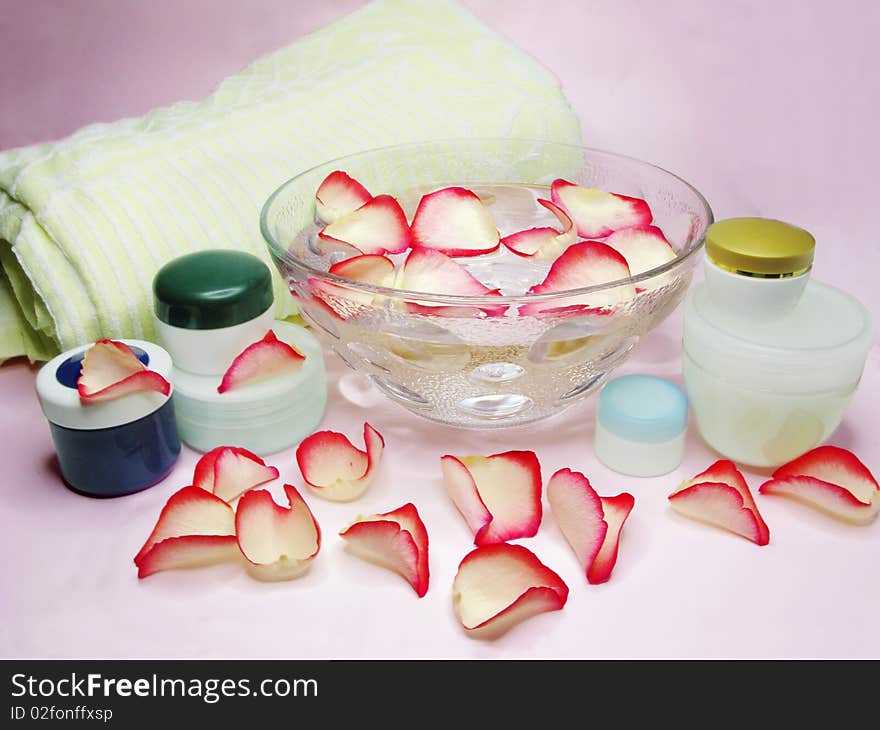 Spa bowl with rose petals and cremes