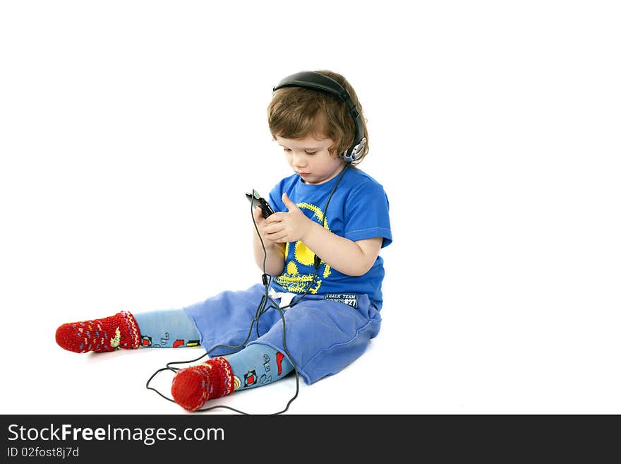 Cute serious child looking in his Mp3 player. Cute serious child looking in his Mp3 player