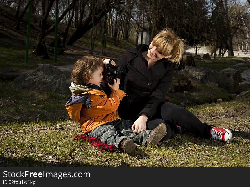 Cute child taking pictures of his mother. Cute child taking pictures of his mother