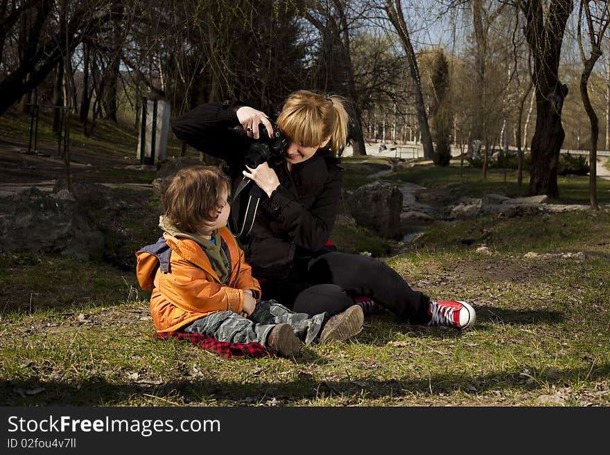 Woman taking pictures of her cute son. Woman taking pictures of her cute son