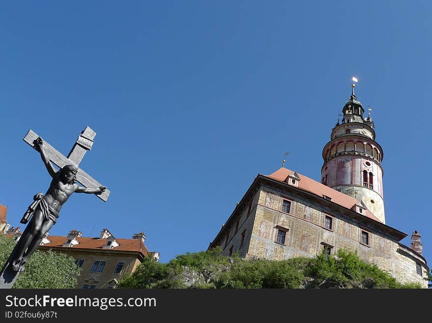 Cross of jesus and  the church in Cesky Krumlov of Czech. Cross of jesus and  the church in Cesky Krumlov of Czech.