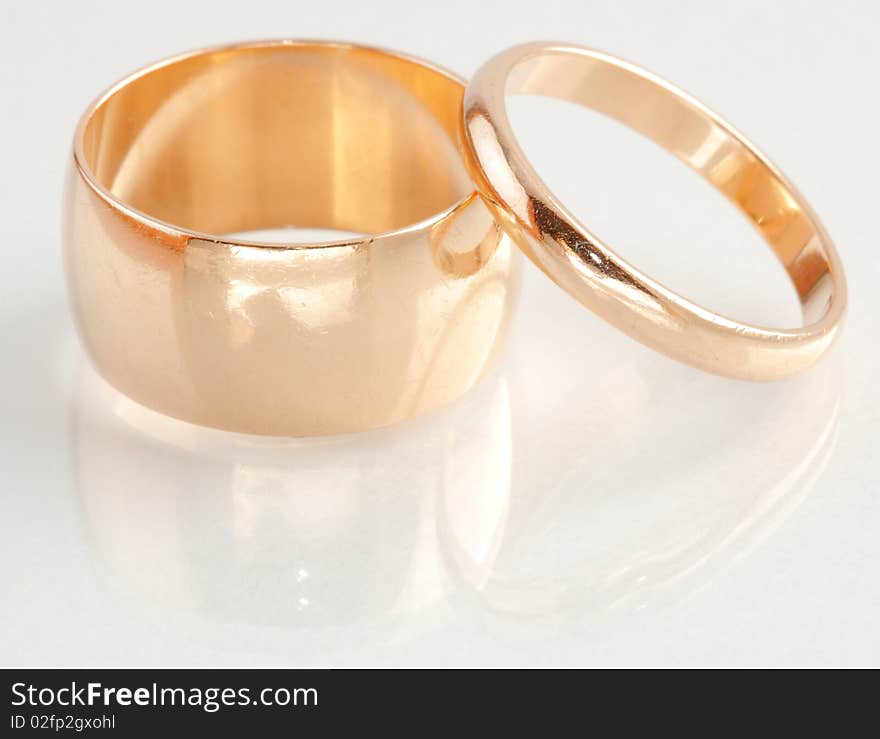 Closeup view of two gold rings with different sizes