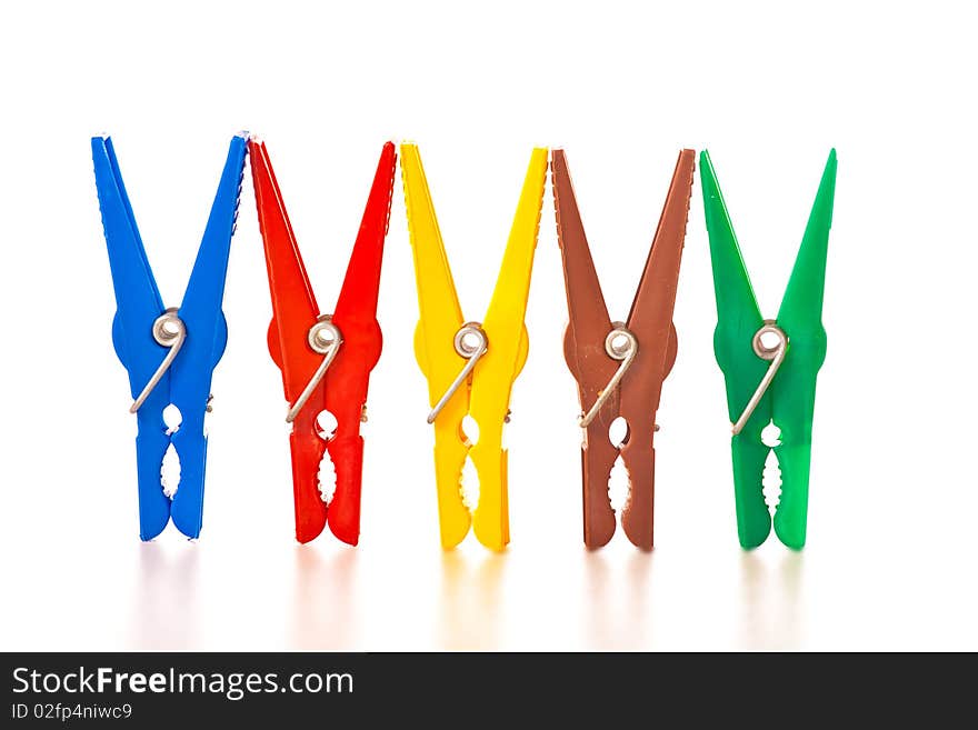 Colorful plastic clothes pins on white isolated