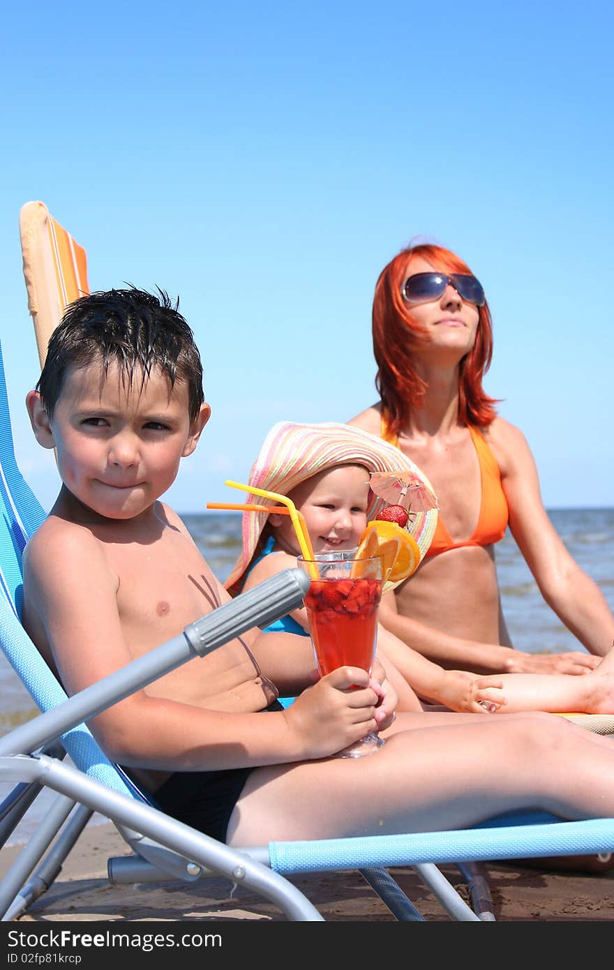 Young family relaxing on beach (boy in focus)