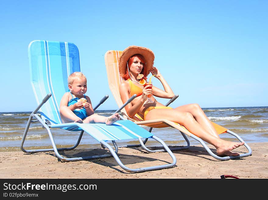 Young mother with little daugher on the beach. Young mother with little daugher on the beach