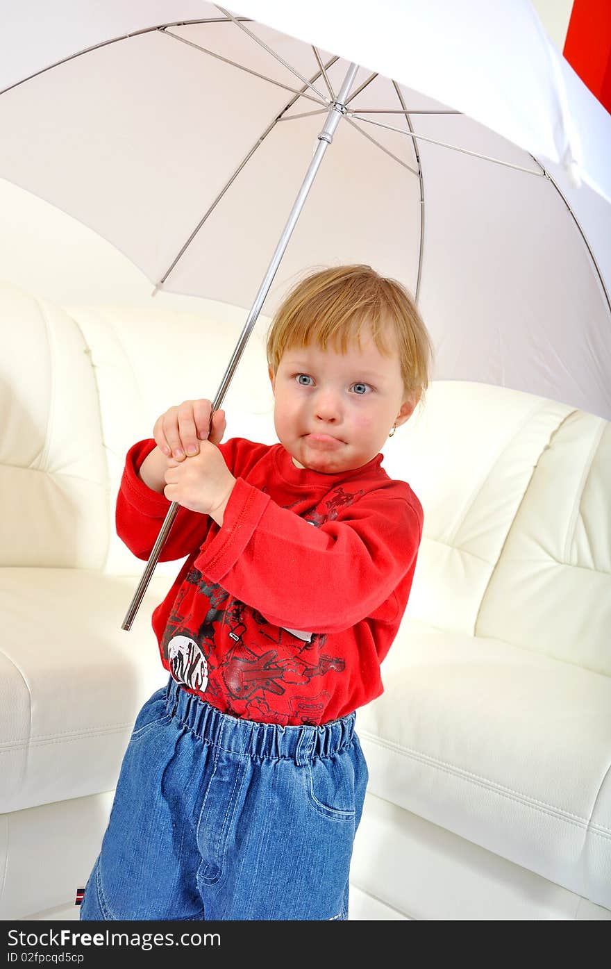 Child is making a face with umbrella. Child is making a face with umbrella