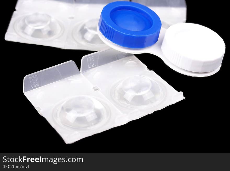 Contact lens with container isolated on black