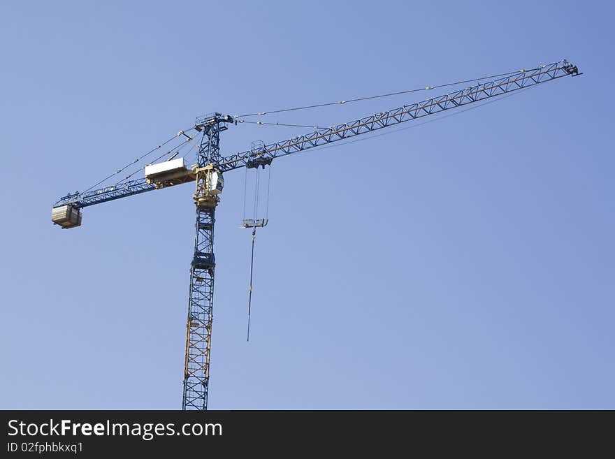 Buildng crane on blue sky background