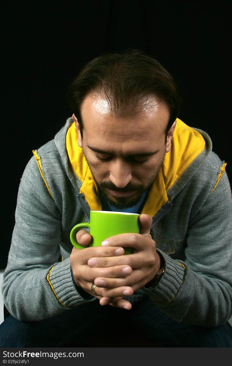 An image of a charismatic man drinking tea. An image of a charismatic man drinking tea