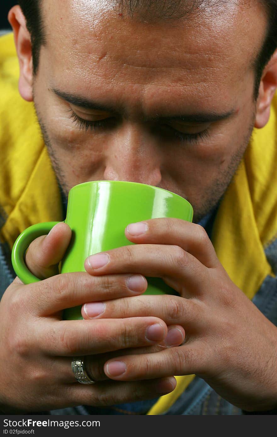 An image of a charismatic man drinking tea. An image of a charismatic man drinking tea