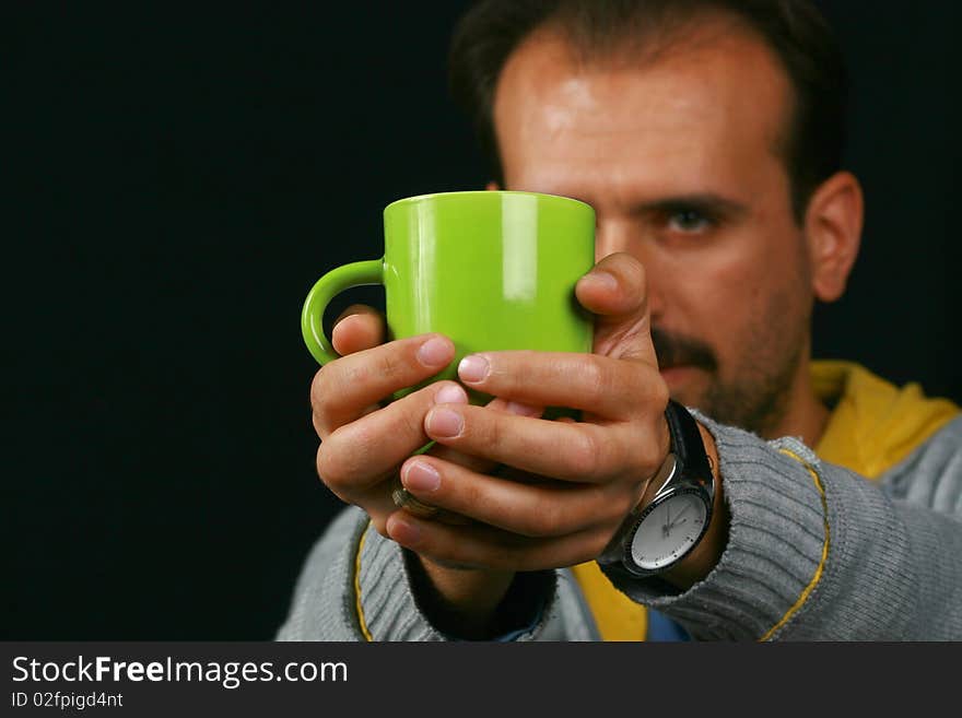 An image of a charismatic man drinking tea. An image of a charismatic man drinking tea