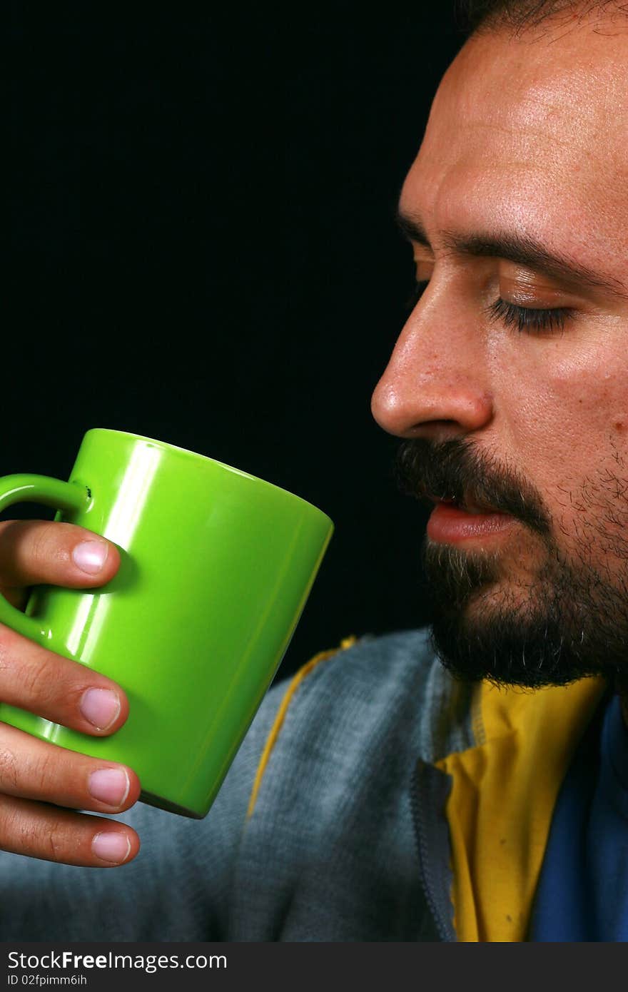 While the image of a charismatic man drinking tea. While the image of a charismatic man drinking tea