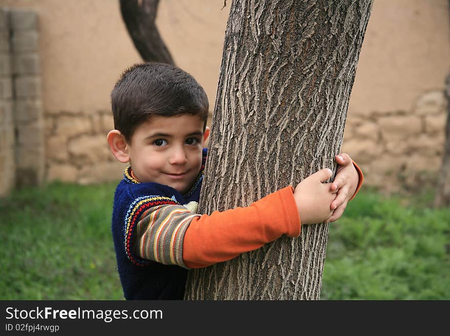 The boy is proud to hold the tree. The boy is proud to hold the tree