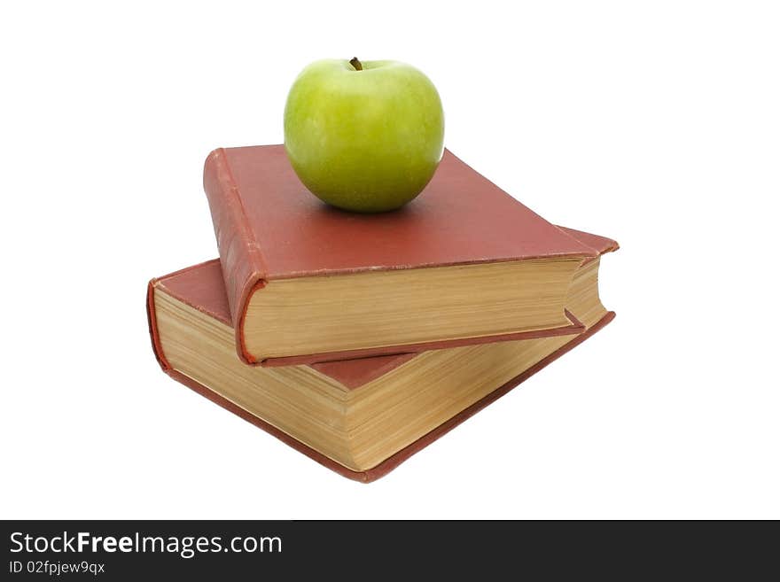 Two old red books and green apple