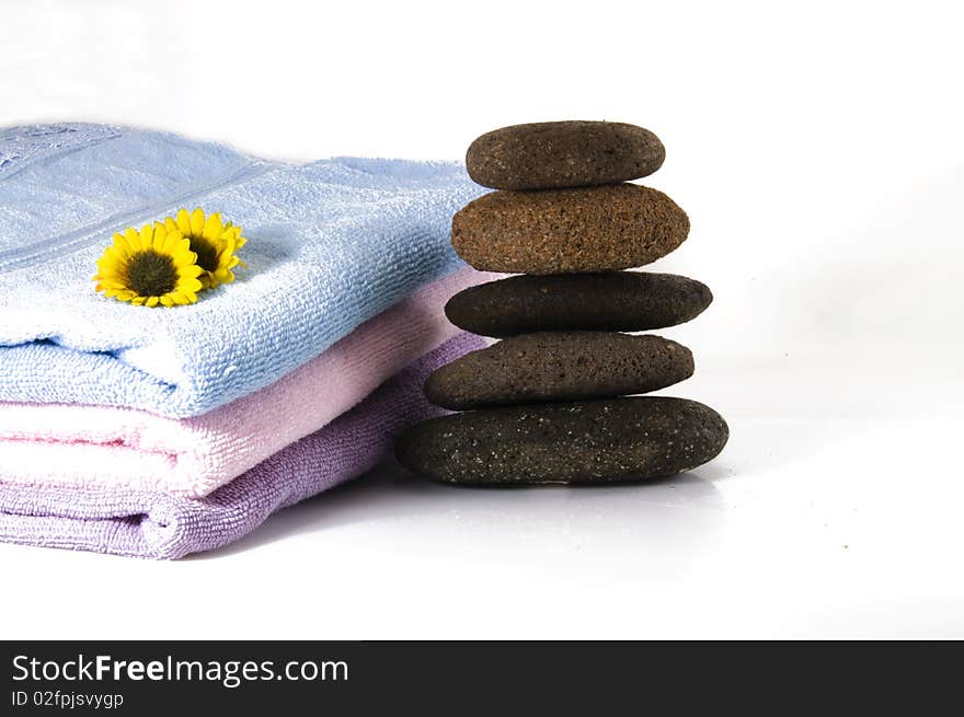 Candles, towel, massage stones and flowers. Candles, towel, massage stones and flowers