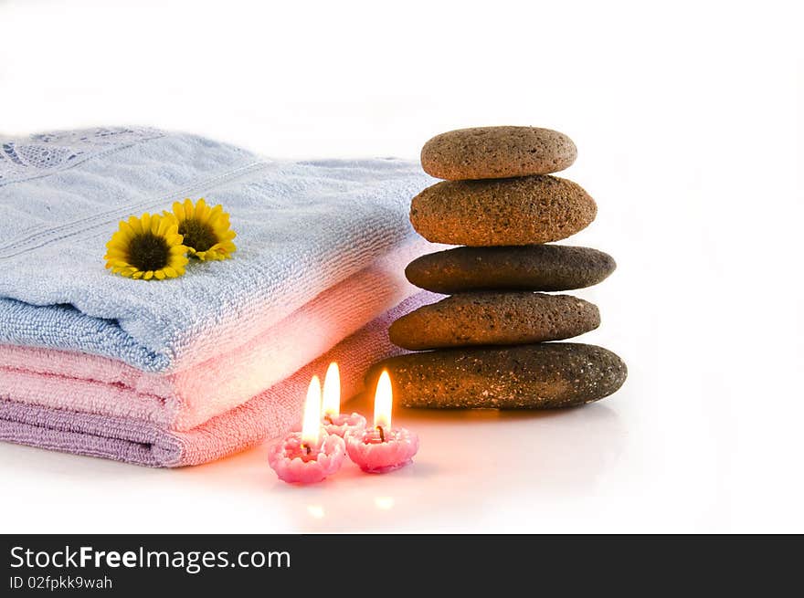 Candles, towel, massage stones and flowers. Candles, towel, massage stones and flowers