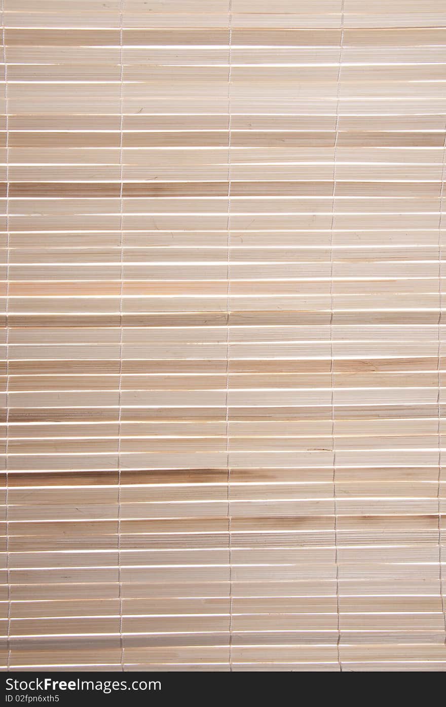 Backlit bamboo shade background image with light colored wood.