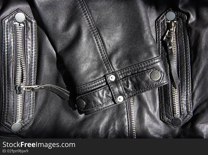 The details of a black leather jacket。Very nice metal button。