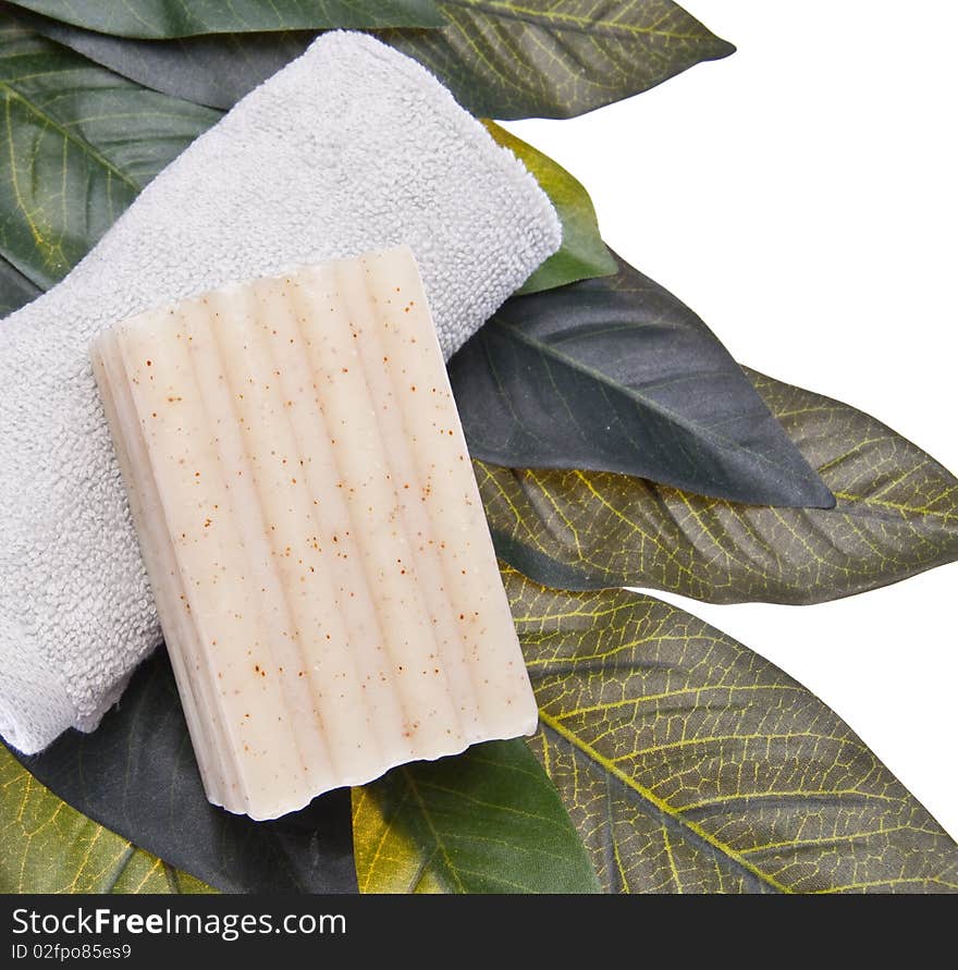 Spa scene with soap, and towel on a leaf background isolated on white with a clipping path.