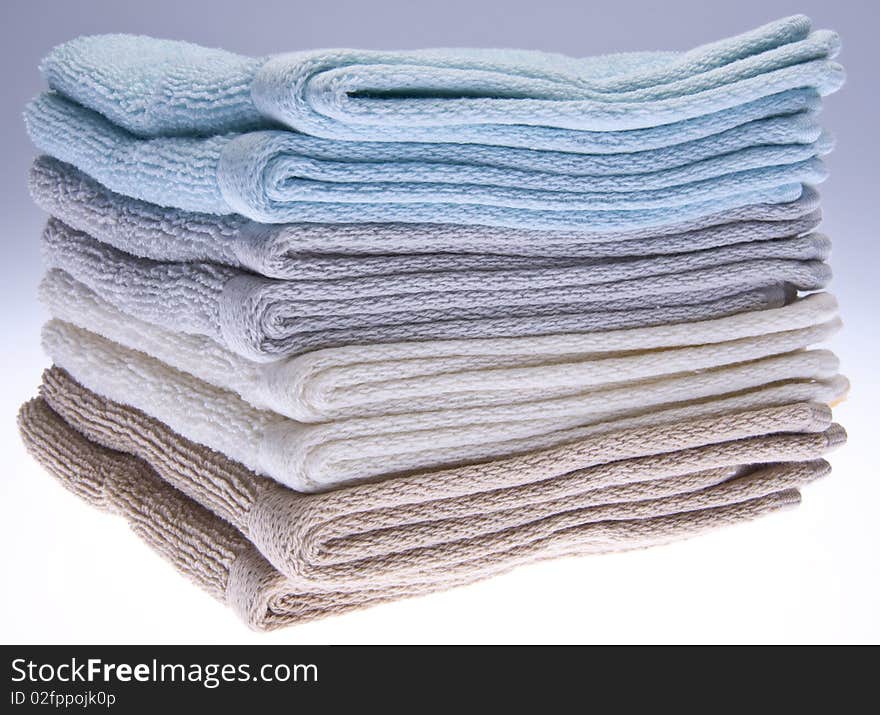 Neutral colored bath towels made of terry cloth.