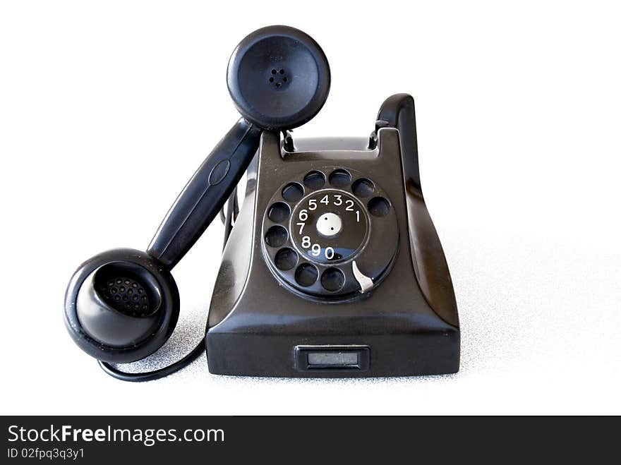 Black retro telephone on white