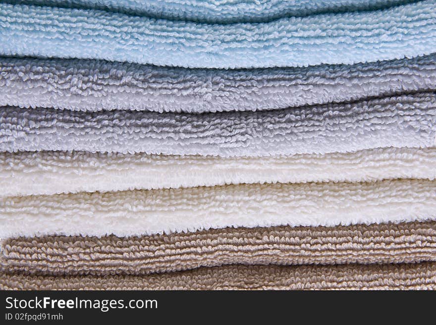 Neutral colored bath towels made of terry cloth.