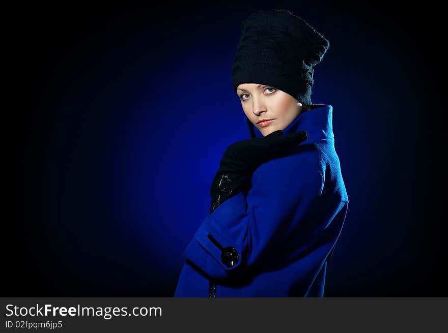 Young lady dressed in a blue topcoat and black hat. Young lady dressed in a blue topcoat and black hat