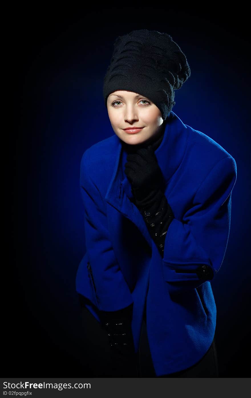 Young lady dressed in a blue topcoat and black hat. Young lady dressed in a blue topcoat and black hat