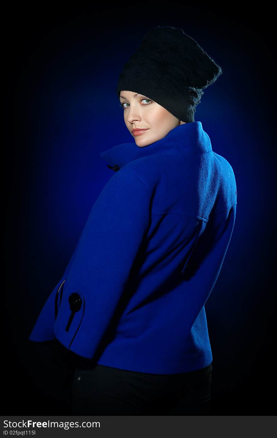 Young lady dressed in a blue topcoat and black hat. Young lady dressed in a blue topcoat and black hat