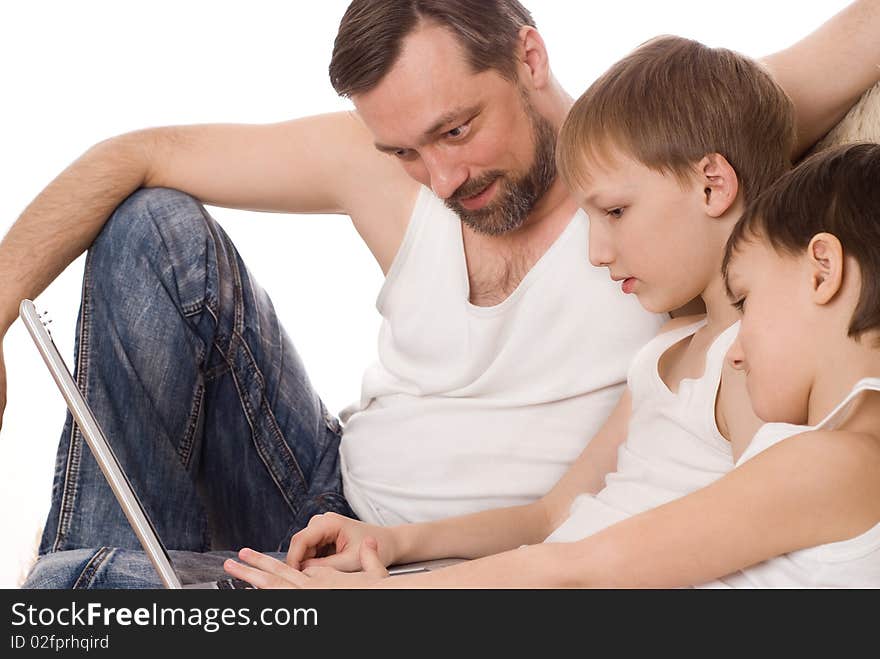 Young father with two sons with laptop