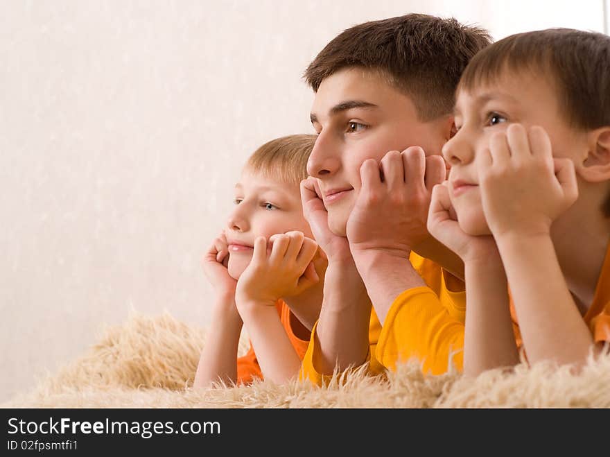 Three brothers in orange shirts