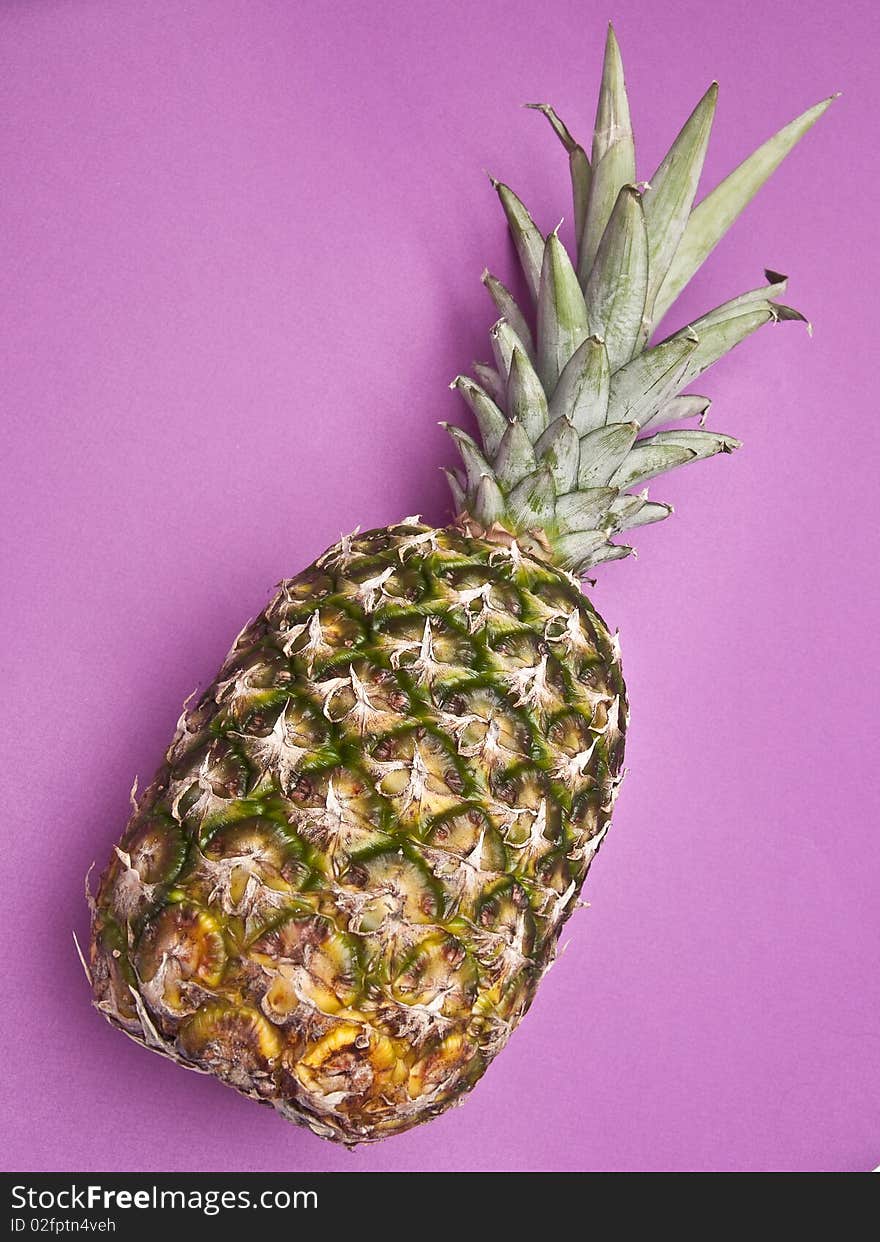 Pineapple on a vibrant purple colored background. Pineapple on a vibrant purple colored background