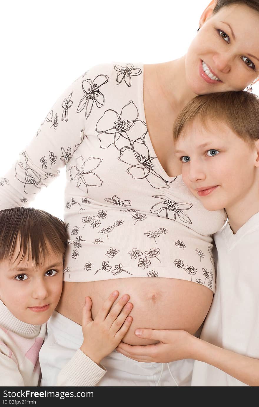 Pregnant woman standing with her two sons