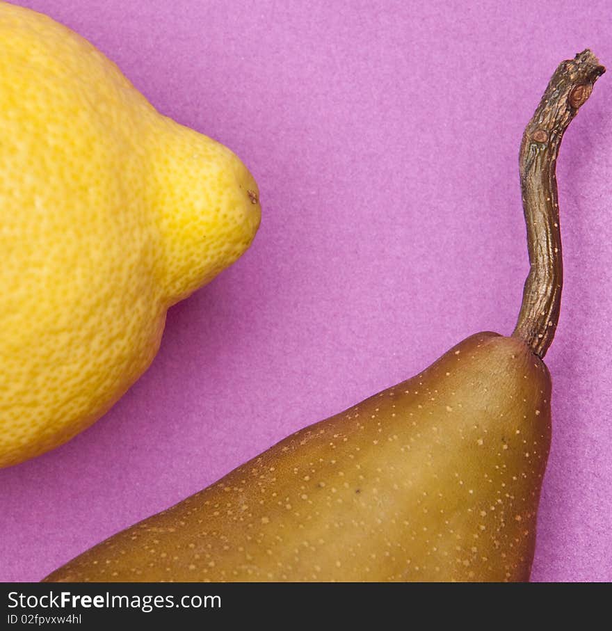 Lemon and Pear on a vibrant purple colored background. Lemon and Pear on a vibrant purple colored background