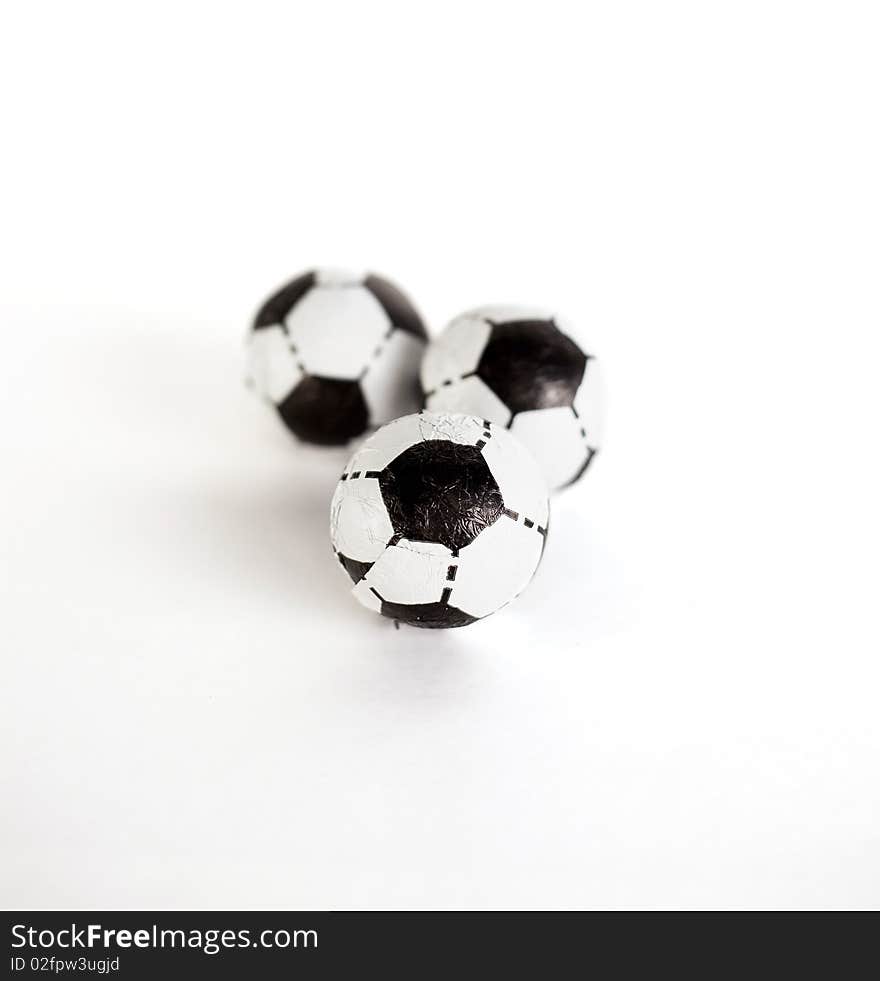 Three little footballs on a white background