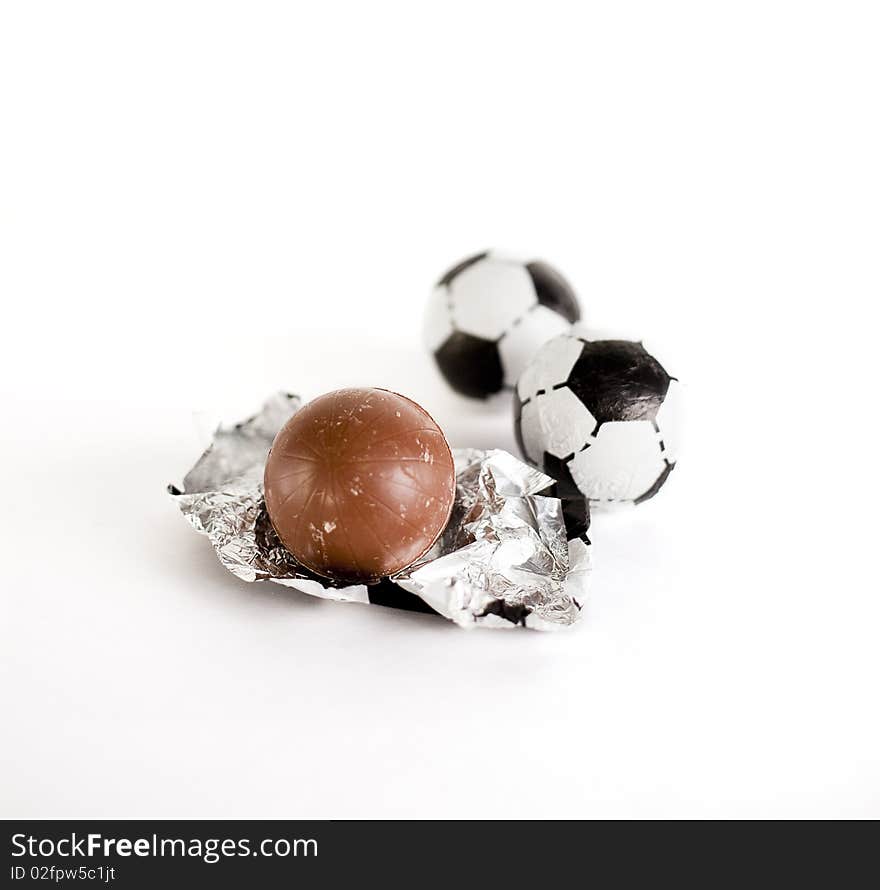 Little chocolate footballs on a white background