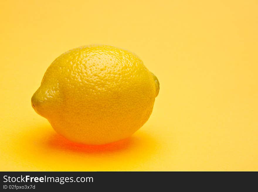 Lemon on a vibrant yellow background. Lemon on a vibrant yellow background.