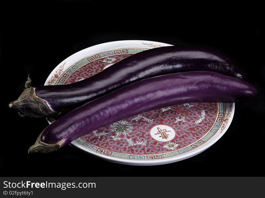 Chinese eggplants on Chinese pattern plate.